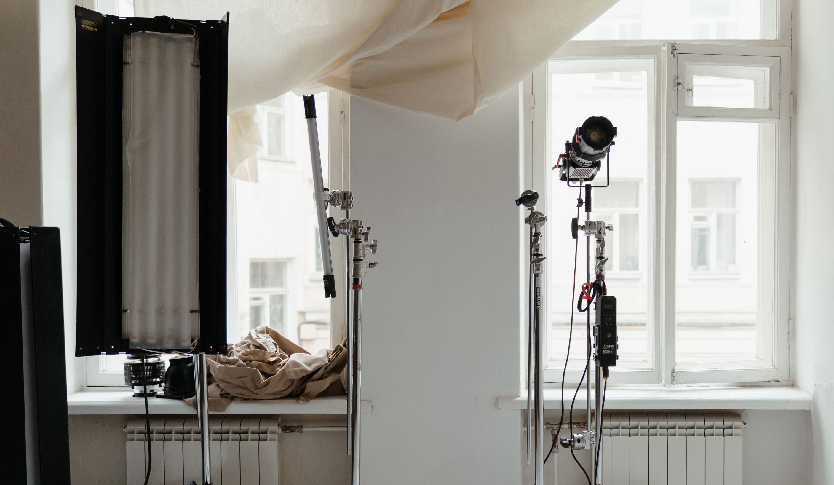 A photography set with studio lighting beside a bright window.